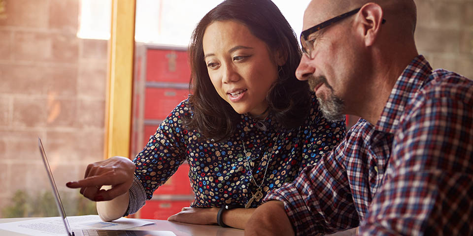 two people working together at a computer